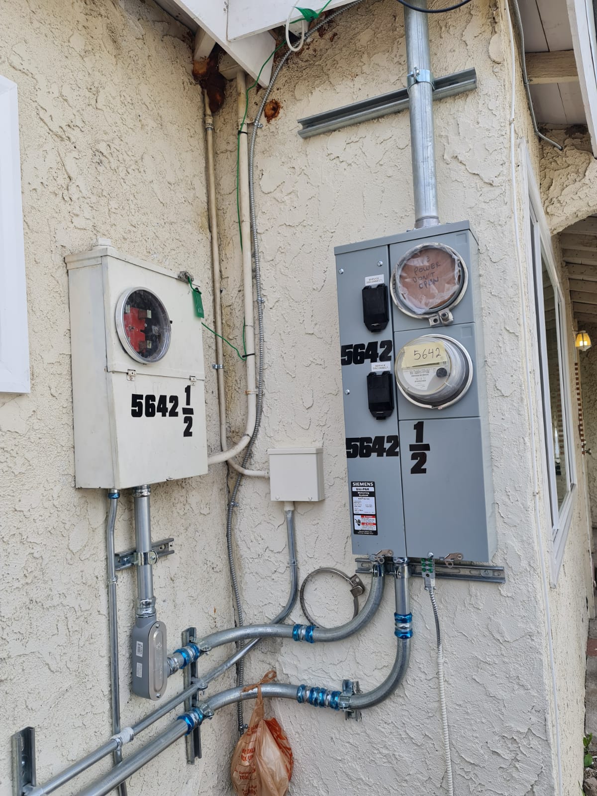 Dual Meter Service On Stucco Wall — INE Electrical Service job photo