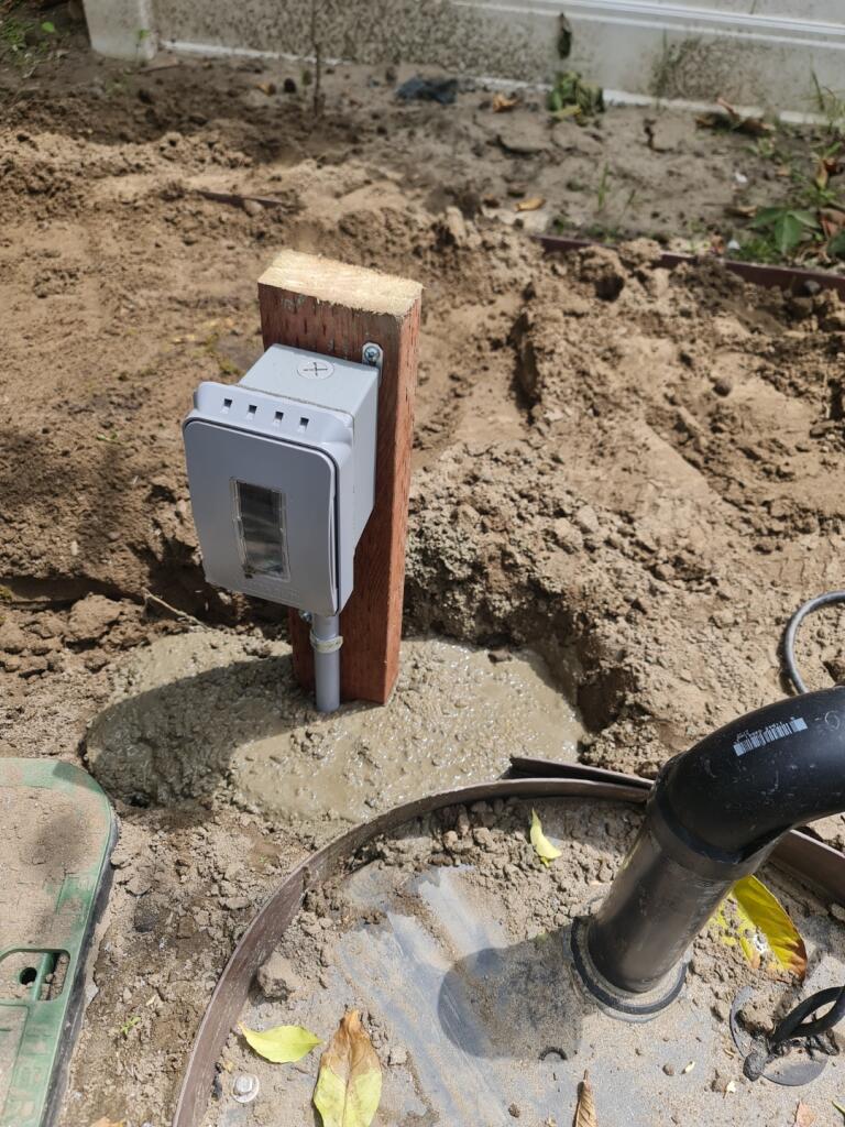 Sump Pump Outlet On Wood Post Closeup — INE Electrical Service job photo